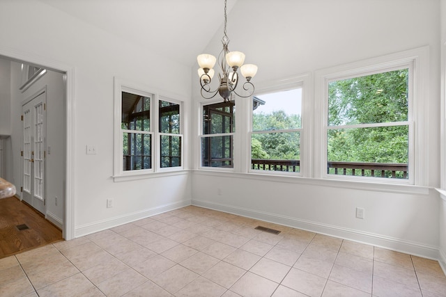 9539 Shadow Crossing Ln, Chattanooga, TN 37421 - unfurnished dining area featuring light tile patterned floors, healthy amount of natural light, a chandelier, and vaulted ceiling