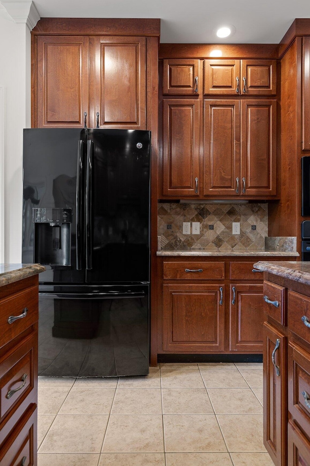 9539 Shadow Crossing Ln, Chattanooga, TN 37421 - kitchen featuring black fridge, light tile patterned flooring, stone countertops, recessed lighting, and tasteful backsplash
