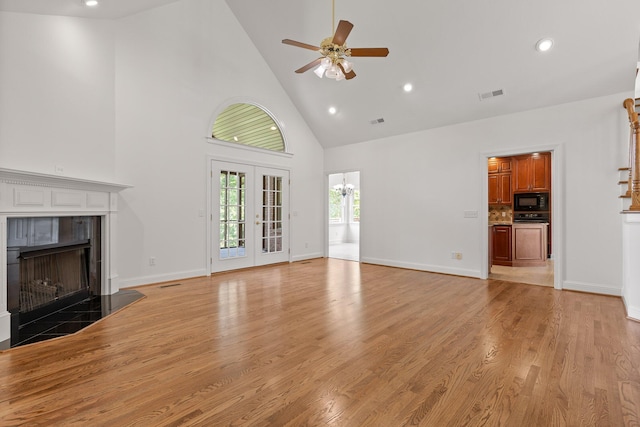 9539 Shadow Crossing Ln, Chattanooga, TN 37421 - unfurnished living room featuring high vaulted ceiling, a ceiling fan, a tile fireplace, recessed lighting, and light wood-style floors