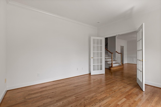 9539 Shadow Crossing Ln, Chattanooga, TN 37421 - empty room with french doors, light wood finished floors, ornamental molding, and stairs
