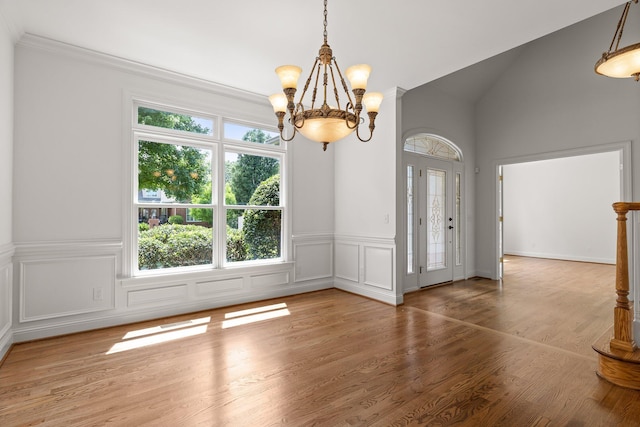 9539 Shadow Crossing Ln, Chattanooga, TN 37421 - unfurnished dining area featuring a chandelier, wood finished floors, a decorative wall, a wainscoted wall, and ornamental molding