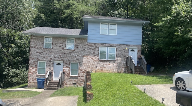 221 Cliftview Dr, Chattanooga, TN 37415 - tri-level home featuring a front yard, brick siding, and view of wooded area