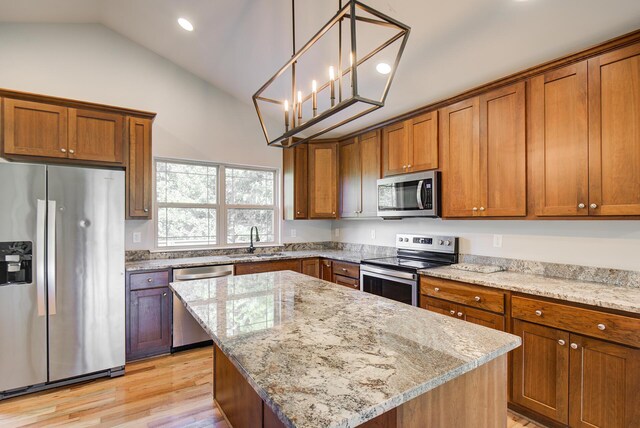 6253 River Stream Dr, Harrison, TN 37341 - kitchen with stainless steel appliances, brown cabinets, light stone countertops, recessed lighting, and high vaulted ceiling