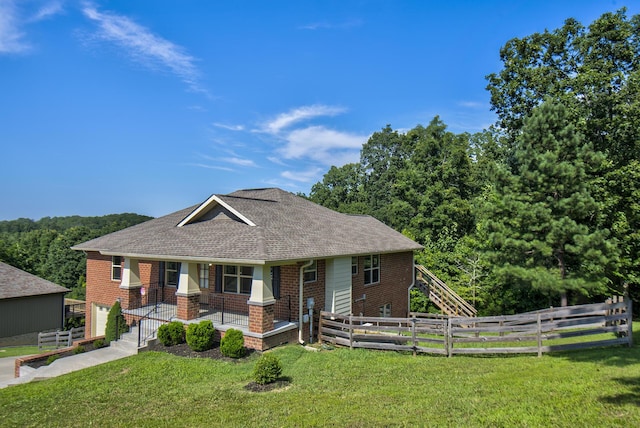 6253 River Stream Dr, Harrison, TN 37341 - view of front of home with brick siding, a fenced backyard, a porch, roof with shingles, and an attached garage