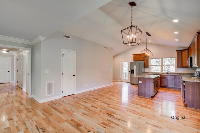 6253 River Stream Dr, Harrison, TN 37341 - kitchen with stainless steel appliances, a chandelier, a kitchen island, ornamental molding, and light wood-type flooring