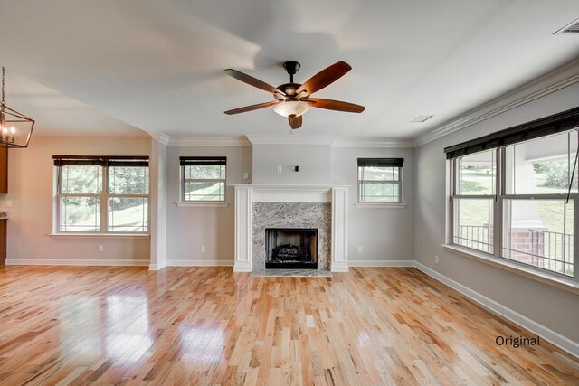 6253 River Stream Dr, Harrison, TN 37341 - unfurnished living room featuring light wood-type flooring, a premium fireplace, ceiling fan, ornamental molding, and a chandelier