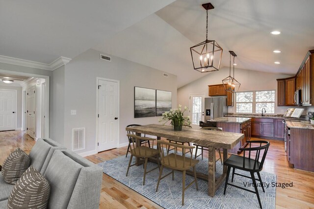 6253 River Stream Dr, Harrison, TN 37341 - dining area with a chandelier, crown molding, light wood-style floors, vaulted ceiling, and recessed lighting