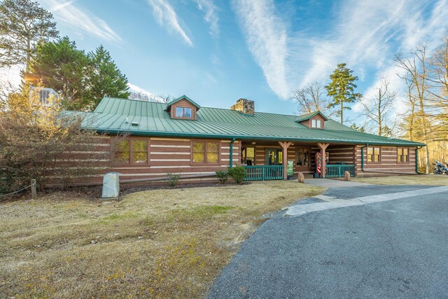 6253 River Stream Dr, Harrison, TN 37341 - log cabin with covered porch, driveway, a chimney, and a metal roof