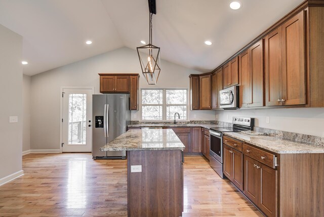 6253 River Stream Dr, Harrison, TN 37341 - kitchen featuring stainless steel appliances, a kitchen island, vaulted ceiling, light stone countertops, and hanging light fixtures