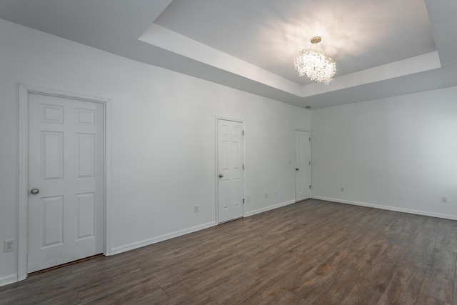 846 Altamont Rd, Chattanooga, TN 37415 - spare room with a tray ceiling, a chandelier, and dark wood-style flooring