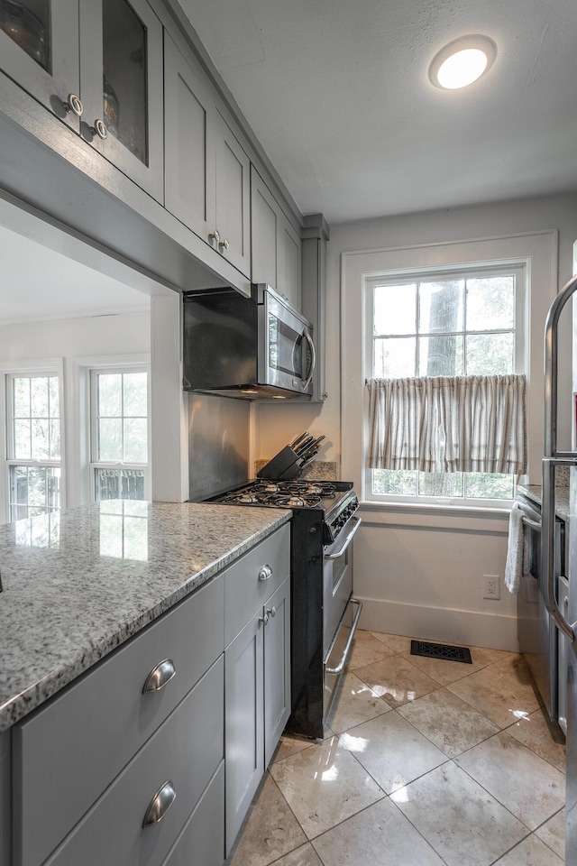 2 Mother Goose Vlg, Lookout Mountain, GA 30750 - kitchen with gray cabinets, appliances with stainless steel finishes, light stone counters, and light tile patterned floors