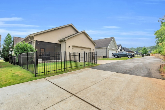 9253 Skyfall Dr, Ooltewah, TN 37363 - view of side of property featuring concrete driveway, a fenced front yard, an attached garage, and stucco siding