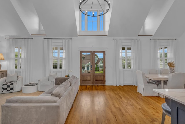 9253 Skyfall Dr, Ooltewah, TN 37363 - living area featuring light wood-style floors, plenty of natural light, a chandelier, and high vaulted ceiling