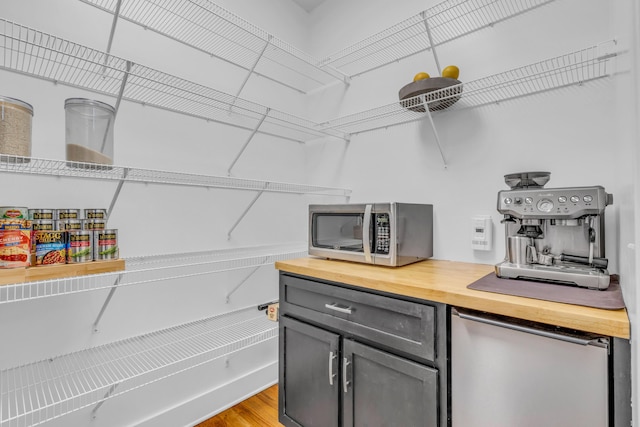 9253 Skyfall Dr, Ooltewah, TN 37363 - kitchen featuring butcher block countertops, stainless steel microwave, refrigerator, light wood-type flooring, and gray cabinets
