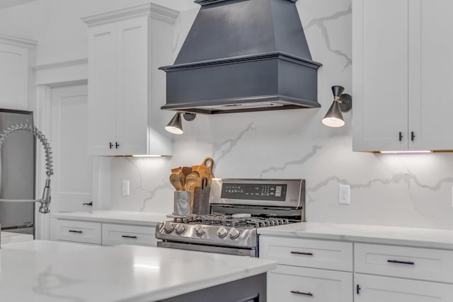 9253 Skyfall Dr, Ooltewah, TN 37363 - kitchen featuring custom exhaust hood, stainless steel gas range, white cabinets, decorative backsplash, and fridge