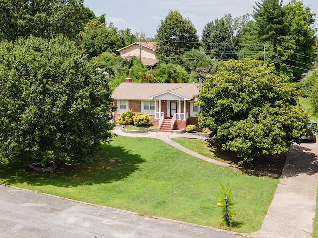 6413 Edgmon Dr, Chattanooga, TN 37421 - view of front of house featuring brick siding, a front lawn, and a chimney