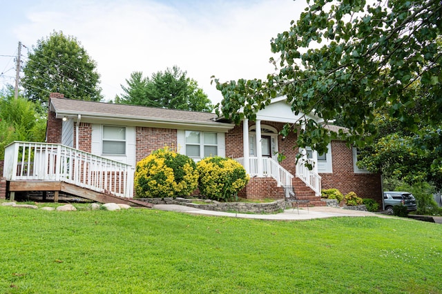 6413 Edgmon Dr, Chattanooga, TN 37421 - view of front of home featuring brick siding, a front lawn, and a chimney
