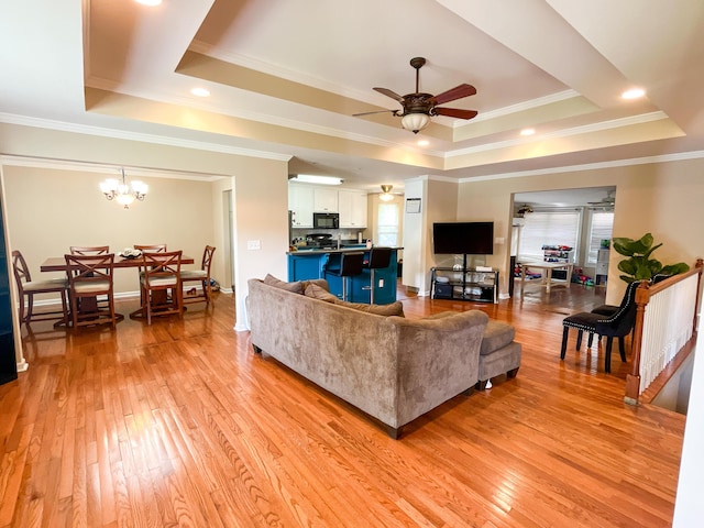 6413 Edgmon Dr, Chattanooga, TN 37421 - living room with a tray ceiling, ornamental molding, plenty of natural light, light wood-style flooring, and a ceiling fan