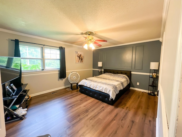 6413 Edgmon Dr, Chattanooga, TN 37421 - bedroom with ornamental molding, dark wood-style floors, a textured ceiling, and a ceiling fan