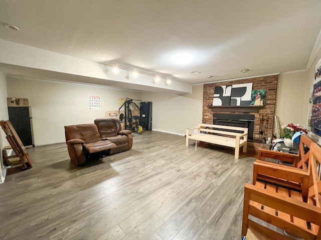 6413 Edgmon Dr, Chattanooga, TN 37421 - living area with track lighting, wood finished floors, a fireplace, and a textured ceiling