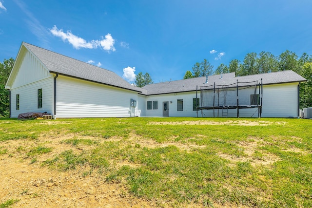 143 Walden Dr, Signal Mountain, TN 37377 - back of house featuring board and batten siding, a lawn, and a trampoline