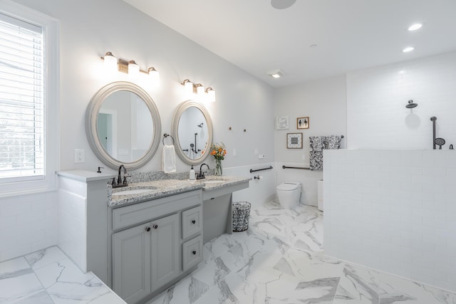 143 Walden Dr, Signal Mountain, TN 37377 - full bathroom with marble finish floors, double vanity, a wainscoted wall, recessed lighting, and tile walls