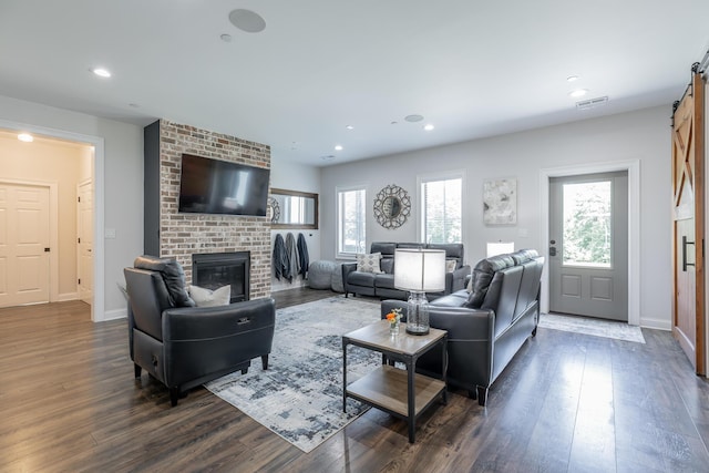 143 Walden Dr, Signal Mountain, TN 37377 - living room featuring a barn door, a brick fireplace, dark wood finished floors, and recessed lighting