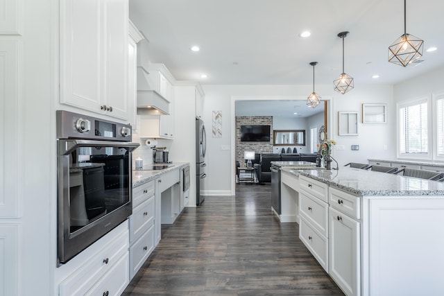 143 Walden Dr, Signal Mountain, TN 37377 - kitchen featuring appliances with stainless steel finishes, open floor plan, white cabinets, tasteful backsplash, and recessed lighting