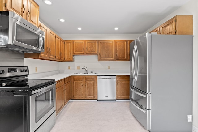 4920 Pine Cir, Ooltewah, TN 37363 - kitchen with stainless steel appliances, light countertops, recessed lighting, and brown cabinetry