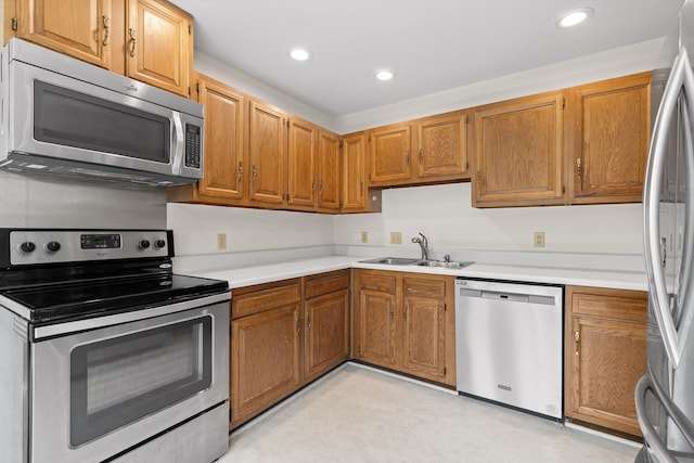4920 Pine Cir, Ooltewah, TN 37363 - kitchen featuring stainless steel appliances, light countertops, recessed lighting, and brown cabinets
