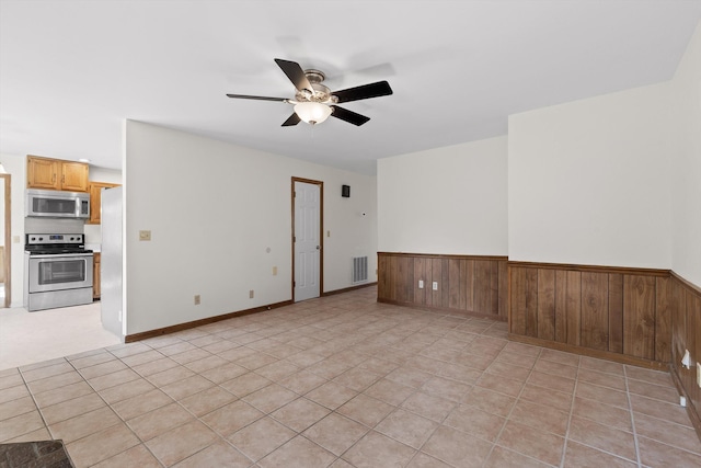 4920 Pine Cir, Ooltewah, TN 37363 - unfurnished room with a ceiling fan, a wainscoted wall, and wooden walls