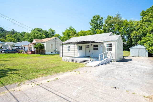 103 Laurel Dr, Chattanooga, TN 37415 - view of front of house with a porch, a front yard, and a storage unit