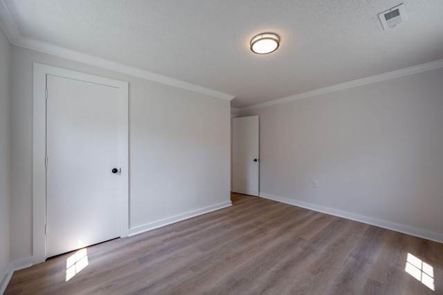 103 Laurel Dr, Chattanooga, TN 37415 - unfurnished bedroom featuring wood finished floors, ornamental molding, and a textured ceiling
