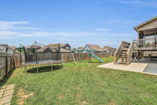 7459 Red Poppy Dr, Ooltewah, TN 37363 - fenced backyard with a trampoline, stairway, a playground, a patio area, and a deck