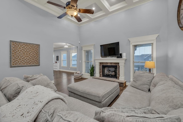7459 Red Poppy Dr, Ooltewah, TN 37363 - living area featuring a high ceiling, ornamental molding, healthy amount of natural light, wood finished floors, and arched walkways