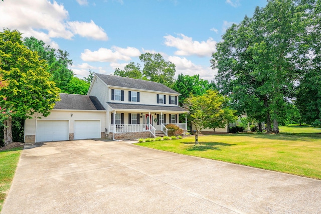 8616 River Cove Dr, Harrison, TN 37341 - colonial home with a porch, a garage, driveway, a front lawn, and roof with shingles