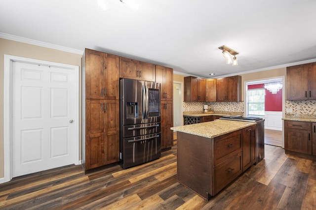 8616 River Cove Dr, Harrison, TN 37341 - kitchen with stainless steel refrigerator with ice dispenser, ornamental molding, dark wood-type flooring, backsplash, and a center island