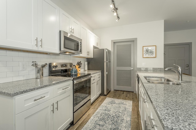 804 Riverfront Pkwy Unit 401, Chattanooga, TN 37402 - kitchen with stainless steel appliances, light stone countertops, light wood-style floors, and tasteful backsplash