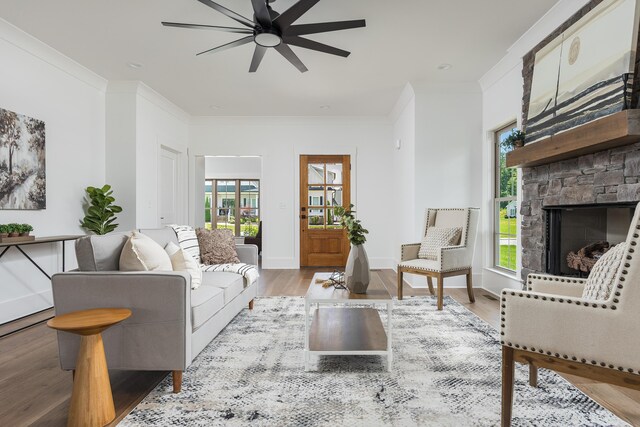 234 Goose Creek Cir, Soddy Daisy, TN 37379 - living area featuring ceiling fan, ornamental molding, a stone fireplace, and wood finished floors