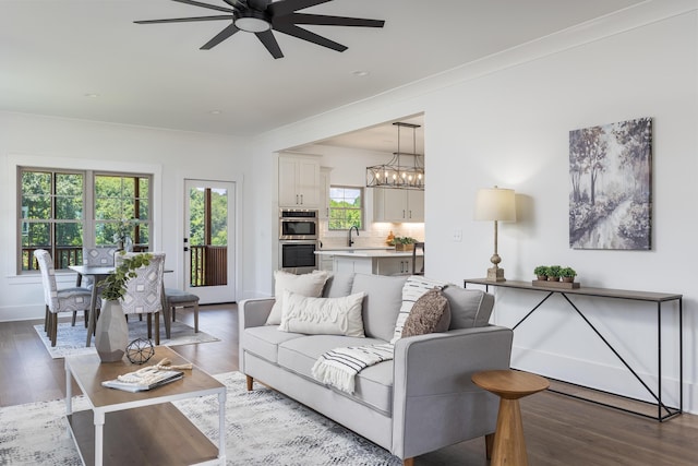 234 Goose Creek Cir, Soddy Daisy, TN 37379 - living area with a ceiling fan, a chandelier, crown molding, and dark wood-style flooring