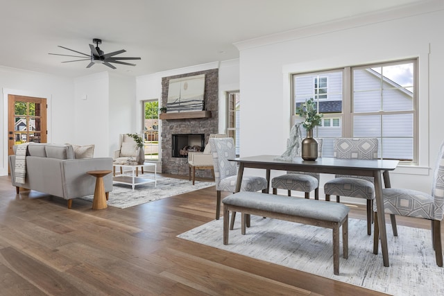 234 Goose Creek Cir, Soddy Daisy, TN 37379 - dining space featuring crown molding, wood finished floors, a stone fireplace, plenty of natural light, and ceiling fan