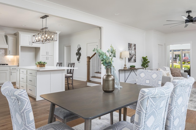 234 Goose Creek Cir, Soddy Daisy, TN 37379 - dining space featuring dark wood-style floors, ornamental molding, ceiling fan, stairs, and a chandelier