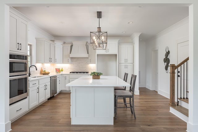 234 Goose Creek Cir, Soddy Daisy, TN 37379 - kitchen with custom range hood, appliances with stainless steel finishes, a chandelier, ornamental molding, and tasteful backsplash