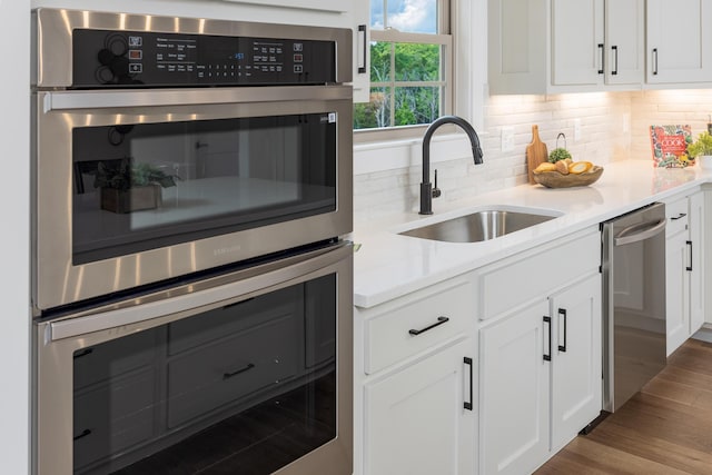 234 Goose Creek Cir, Soddy Daisy, TN 37379 - kitchen featuring appliances with stainless steel finishes, tasteful backsplash, and white cabinets