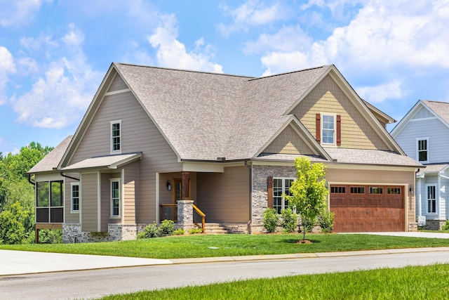 234 Goose Creek Cir, Soddy Daisy, TN 37379 - craftsman house featuring concrete driveway, a front lawn, stone siding, and roof with shingles