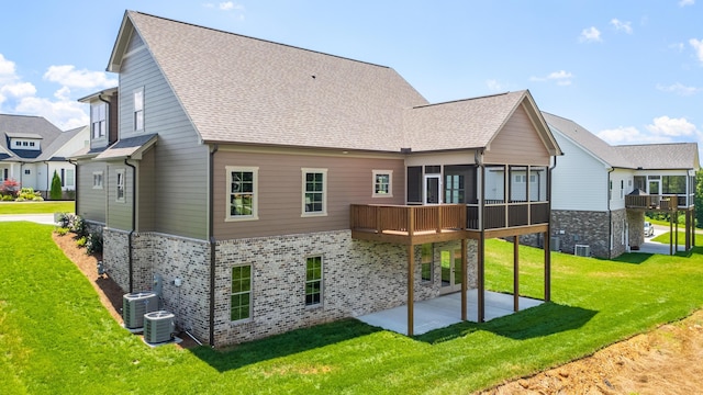 234 Goose Creek Cir, Soddy Daisy, TN 37379 - rear view of property featuring a patio area, a sunroom, a yard, brick siding, and roof with shingles