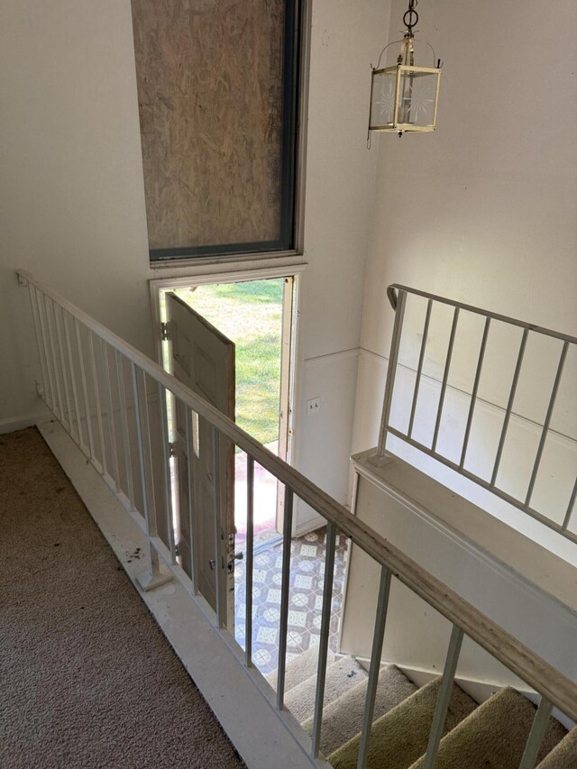 7014 S Dent Rd, Hixson, TN 37343 - stairs with carpet and a chandelier