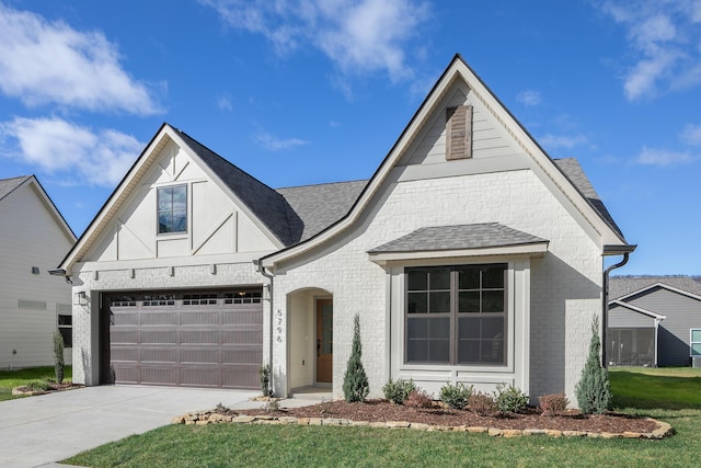 45 Little Sorrel Rd Unit 45, Hixson, TN 37343 - view of front of house featuring driveway, brick siding, roof with shingles, and a front yard