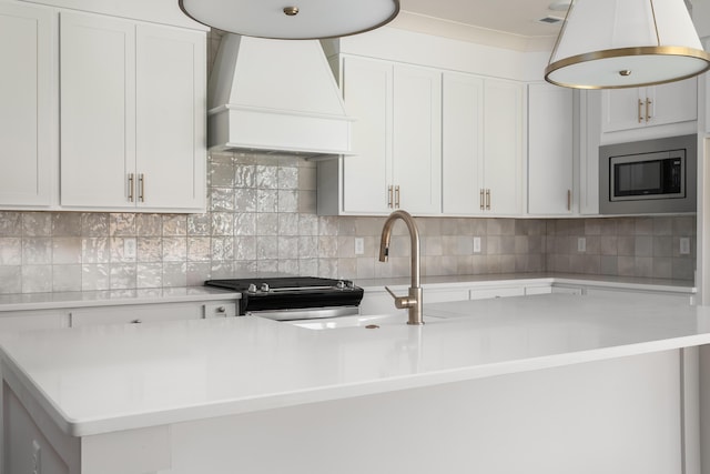 45 Little Sorrel Rd Unit 45, Hixson, TN 37343 - kitchen with custom range hood, stainless steel appliances, light countertops, a center island with sink, and decorative backsplash