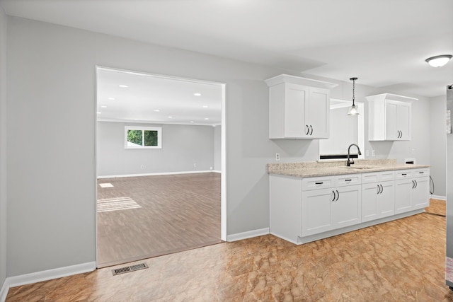 76 Roswell Rd, Rossville, GA 30741 - kitchen with white cabinetry, recessed lighting, open floor plan, decorative light fixtures, and light stone countertops